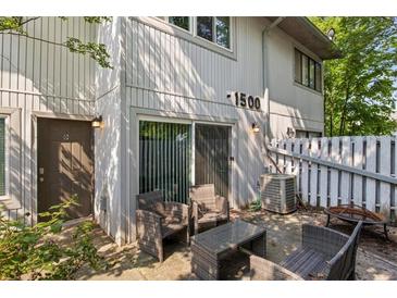 Exterior patio with comfortable wicker seating and a charming fenced yard at 1500 Pine Log #D Ne Rd, Conyers, GA 30012