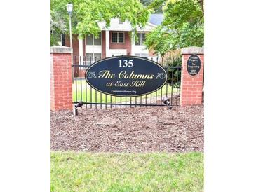 Attractive neighborhood sign with black iron fencing and brick pillars at 135 E Hill St # 22, Decatur, GA 30030