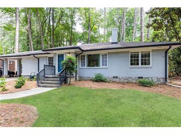 Charming one-story home with a well-manicured lawn and inviting entrance at 1443 Fama Ne Dr, Atlanta, GA 30329