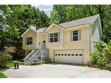Two-story home with neutral siding, shutters, a covered entryway, and attached garage at 540 Alcovy Hills Dr, Lawrenceville, GA 30045