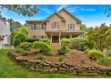 Charming two-story home with landscaped front yard and inviting curb appeal at 1637 Willow Way, Woodstock, GA 30188