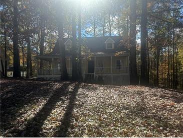 Charming home with a wraparound porch nestled among trees, offering a serene and private setting at 43 Oak Landing Cir, Douglasville, GA 30134