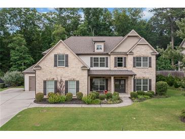 Charming two-story brick home with a well-manicured lawn and inviting curb appeal at 4460 Hunters Walk Way, Cumming, GA 30028