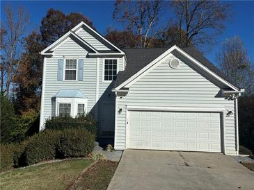 Charming two-story home features a two car garage, light siding, and well-maintained landscaping at 138 Shady View Pl, Lawrenceville, GA 30044