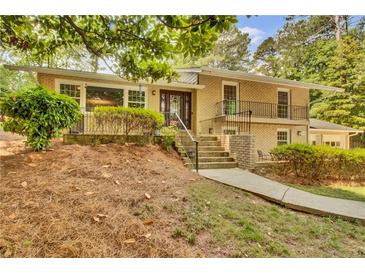 Charming two-story brick home with a manicured lawn, mature trees, and inviting front entry at 4794 Glenbonnie Ct, Atlanta, GA 30360
