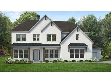 Charming two-story white brick home with a covered porch and beautifully landscaped front yard at 4820 Gadwall Way, Cumming, GA 30028