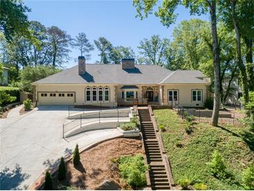 Stunning ranch-style home featuring a well-manicured lawn, attached garage and an extra long, private driveway at 511 Pine Valley Se Rd, Marietta, GA 30067