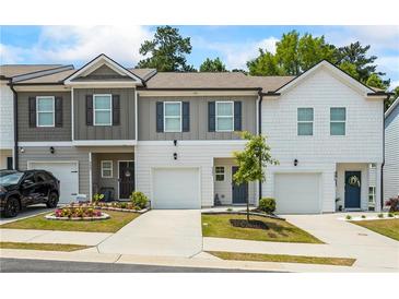 Charming townhomes featuring manicured lawns and driveways leading to attached one-car garages at 3481 Lakeview Crk, Lithonia, GA 30038
