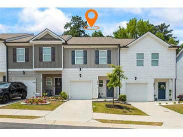 Inviting townhome exterior with single-car garage and well-manicured landscaping at 3481 Lakeview Crk, Lithonia, GA 30038