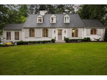 Charming home featuring shuttered windows, dormers, and a well-manicured front lawn at 3916 E Brookhaven Ne Dr, Brookhaven, GA 30319