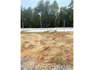 New home construction showing foundation for a single Gathering home surrounded by a wooded lot at 1018 Merritt Dr # 110, Villa Rica, GA 30180