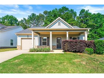 Charming single-story home with a well-manicured lawn and inviting front porch at 175 Orchard Ln, Covington, GA 30014