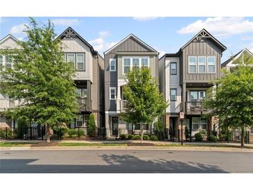 Charming townhome with modern facade, black metal fences, and well-maintained landscaping along the street at 518 Hargrove Ln, Decatur, GA 30030