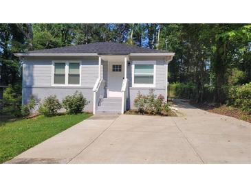 Charming single-story home with a well-manicured lawn and a concrete driveway leading to the front door at 462 Center Hill Ave, Atlanta, GA 30318