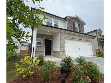 Charming two-story home with brick and stone accents and a two car garage at 2277 Whitworth St, Lawrenceville, GA 30044