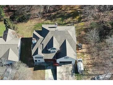 An aerial view of a multi-story home with a large roof, surrounded by trees and ample outdoor space at 3265 Greenhill Ct, Villa Rica, GA 30180