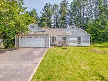 Charming single-story home featuring a well-maintained lawn and an attached two-car garage at 3288 Owens Meadow Ln, Kennesaw, GA 30152