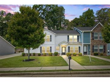 Charming two-story home boasts manicured lawn, tidy shrubbery, and a welcoming facade at 5880 Garden Circle Cir, Douglasville, GA 30135