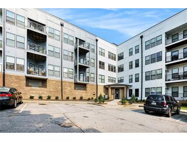 Condominium building with brick facade, multiple balconies and parking lot in front at 898 Oak Sw St # 3420, Atlanta, GA 30310