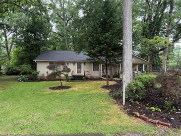 Charming home with lush lawn, mature trees, and well-maintained landscaping at 1268 Woodland Ne Rd, Conyers, GA 30012