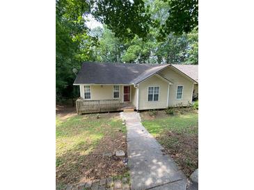 Cozy one-story home featuring a quaint front deck and traditional siding at 5119 Hill Farm Ne Dr, Woodstock, GA 30188