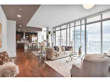 Bright living room with floor-to-ceiling windows and open concept kitchen and dining area at 1065 Peachtree Ne St # 3505, Atlanta, GA 30309