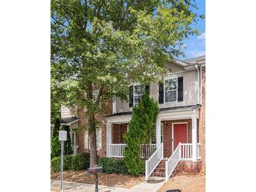 Charming townhome with brick facade, red door, manicured shrubs, and a welcoming front porch at 3262 Cascade Parc Blvd, Atlanta, GA 30311