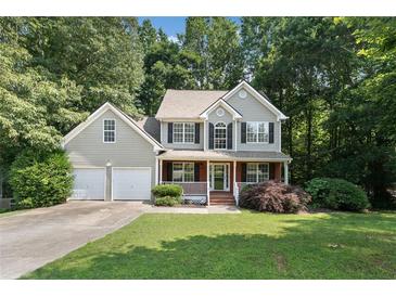 Charming two-story home with a well-manicured lawn, two-car garage, and a welcoming front porch at 14 Augusta Way, Hiram, GA 30141