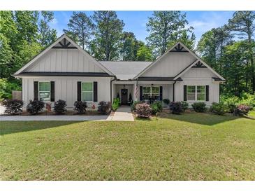 Charming one-story home with a well-manicured lawn, attractive landscaping, and inviting front porch at 2751 Pilgrim Mill Rd, Cumming, GA 30041