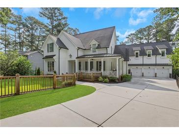 Stunning two-story home with a three-car garage and beautifully landscaped front yard at 4250 Summit Dr, Marietta, GA 30068