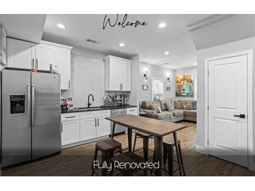 Bright, renovated kitchen with stainless steel appliances and a view of the living room at 1174 Princess Sw Ave, Atlanta, GA 30310