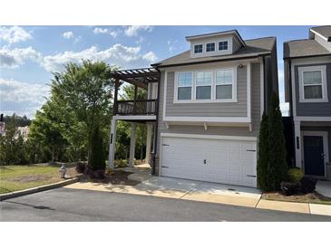 Charming two-story home featuring a balcony, two-car garage and neutral color palette at 301 Hayden Cir, Woodstock, GA 30189
