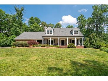 Charming single Gathering home featuring a covered front porch and well-manicured landscaping at 3990 Wesley Chapel Rd, Marietta, GA 30062