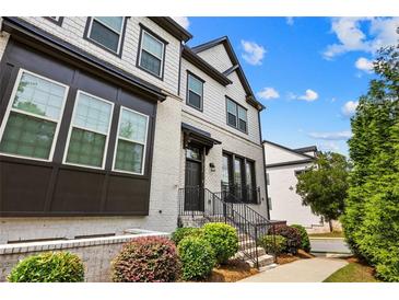 Charming two-story townhome with painted brick, black trim, and beautiful landscaping at 4776 Highside Way, Smyrna, GA 30082