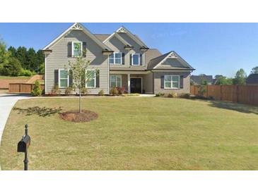 Charming two-story home featuring a manicured lawn, gray siding, black shutters, and a brick-accented porch at 7820 Longview Dr, Cumming, GA 30041