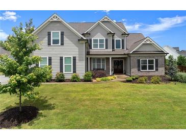 Charming two-story home with landscaped front yard, inviting curb appeal, and a classic architectural design at 7820 Longview Dr, Cumming, GA 30041