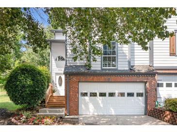 Charming two-story home with a brick-accented garage, steps to a beautiful front door, and landscaped yard at 884 Edgewater Cir, Marietta, GA 30062