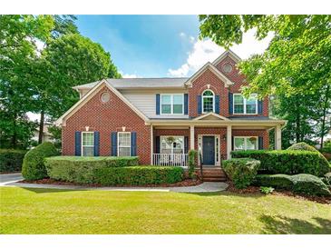 Beautiful two-story brick home with manicured lawn and charming front porch at 1120 Bagwell Dr, Kennesaw, GA 30152