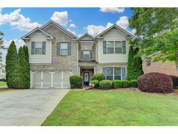 Charming two-story home features a well-manicured lawn, lush landscaping, and a welcoming two-car garage at 2837 Peachstone Ct, Lawrenceville, GA 30043