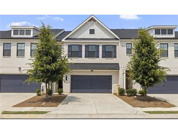 Charming townhome with a modern exterior, featuring a two-car garage and well-manicured front yard at 3546 Sorrel Ln, Duluth, GA 30096