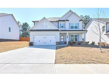 Charming two-story home with a two-car garage and a well-maintained lawn and blue accent shutters at 3557 Bryant Meadows Cir, Buford, GA 30519