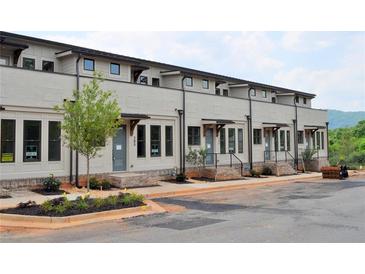 Charming new townhomes with inviting entrances and manicured landscaping line a freshly paved street at 297 White St # 1, Marietta, GA 30060