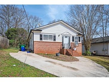 Charming single-story home with brick foundation, white siding, and well-maintained front yard at 3162 Alston Drive Dr, Decatur, GA 30032