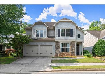 Charming two-story home with stone accents, neutral siding, and well-maintained landscaping and a two car garage at 510 Winder Trl, Canton, GA 30114