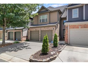 Charming townhome with a two-car garage and manicured landscaping at 1239 Grampian Pass # 11, Marietta, GA 30008
