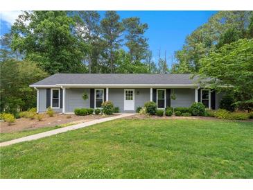 Charming single-story home with well-manicured lawn and gray siding at 3131 Garden Lane Dr, Marietta, GA 30062