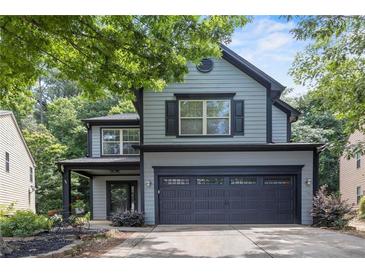 Charming two-story home with a two-car garage, beautifully landscaped front yard, and covered porch at 930 Silver Lake Dr, Acworth, GA 30102
