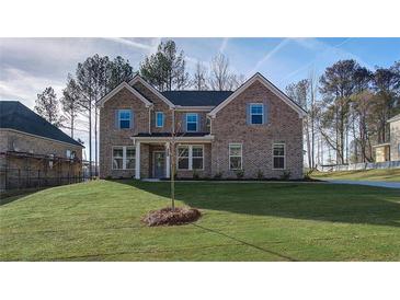 Charming two-story brick home with a manicured lawn and inviting front entrance at 308 Delta Dr, Mcdonough, GA 30253