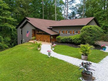 Charming front yard of home featuring manicured landscaping, a stone walkway, and lovely curb appeal at 2674 Skylane Dr, Marietta, GA 30062