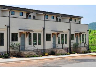 Modern townhome with brick accents, sleek black window frames, and stylish wooden accents over the entryways at 289 White St # 3, Marietta, GA 30060